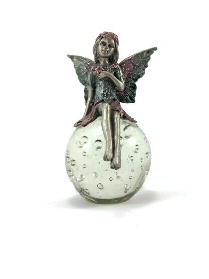 Fairy figurine on crystal globe